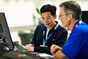 Two men looking at the laptop screen