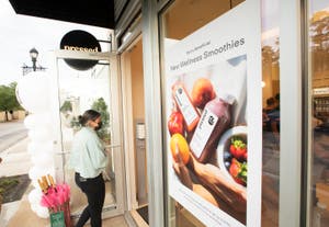 Photo of a poster advertising wellness smoothies at Pressed
