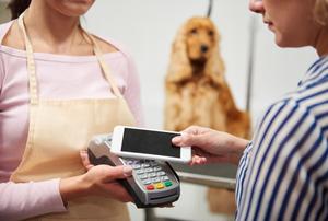 woman checking out using her mobile in a store for a safer and faster checkout method.