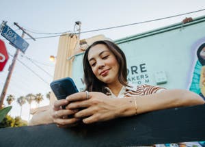 Woman smiling at her phone