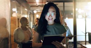 Female lady smiling at a tablet screen