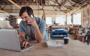 smiling man discussing on phone