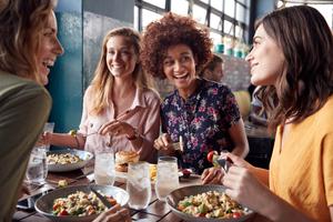 A group of friends enjoy lunch together