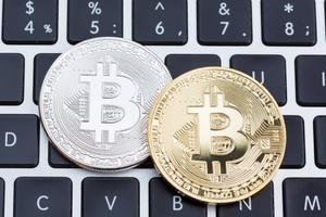 Two coins with the Bitcoin Cash logo lay on top of a keyboard.