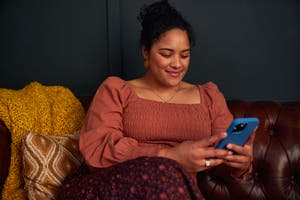 A woman looks at a smartphone