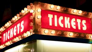 Red sign reading 'Tickets' with lights all around it. 
