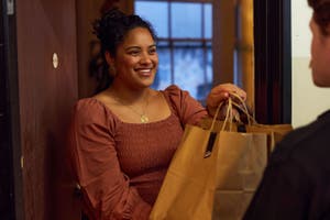 Woman at door to grocery delivery she purchased online