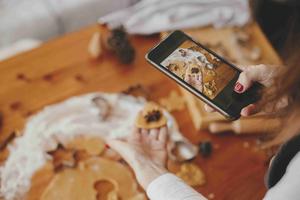 Hand taking a photo of holiday treats with her phone