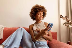 A woman shopping for beauty and wellness products on her smartphone. 