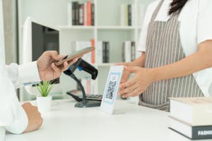 Customer use phones to scan QR codes to pay in-store with digital payments