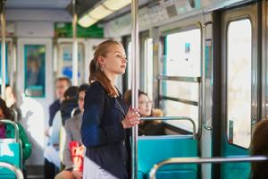 Young woman standing on a subway