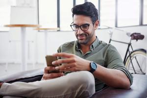 casual businessman looking at his phone