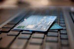 Two credit cards lay on a keyboard.