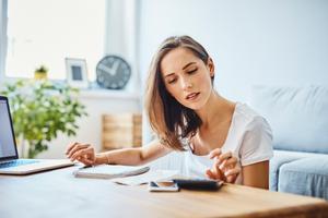 A woman reviews her savings accounts and budget.