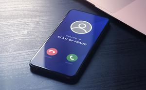 A mobile device displays a ‘fraud or scam’ alert