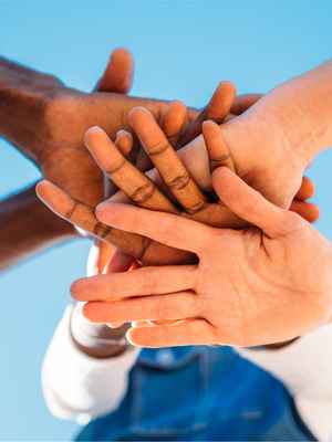 A hand stack, illustrating teamwork and how you can make a difference when you donate or raise money with PayPal.