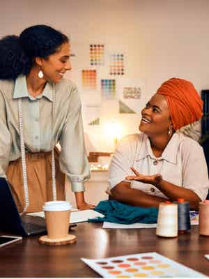 Two business woman in a sewing workshop having a conversation