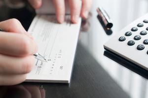 A person writing a cheque