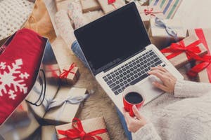 A woman using laptop and doing holiday shopping online