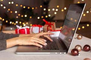 A female using laptop to do holiday shopping online