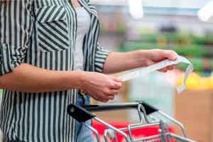 A person reviewing a shopping bill at the supermarket