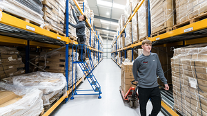 Two men working in a delivery warehouse.