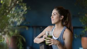 Woman drinking green smoothie.