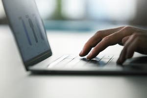 A man shops online on his laptop.