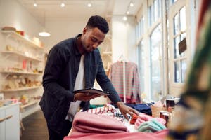 A man looks at a tablet while shopping in-store