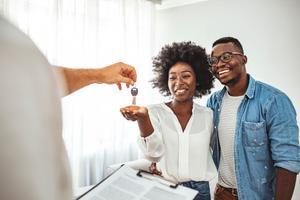 A couple receives keys to their new home.