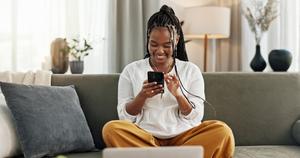 A woman uses her phone to access mobile banking.