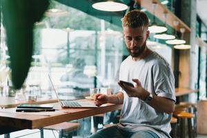 A man uses a mobile banking app on his phone.