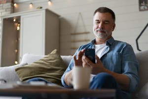 A man makes a purchase with one-click checkout on his phone.