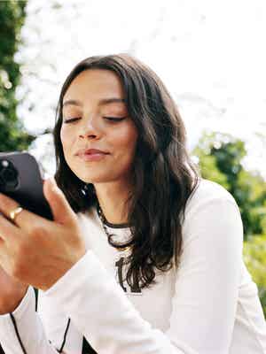 Woman looking at her phone outside