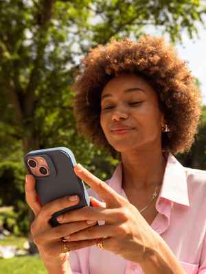 Woman sitting outside looking at her phone