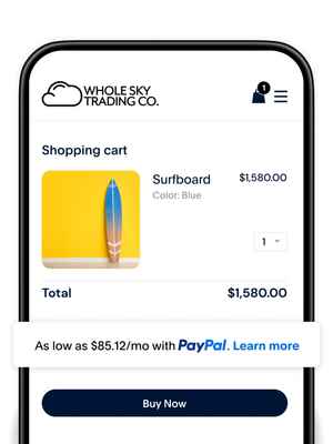 Man standing in front of a rack of surfboards, with a phone screen to make a payment using PayPal Pay Later