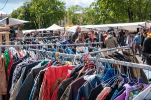 A rack of clothes at a secondhand market.