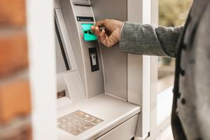 A man takes a cash advance out of an ATM.