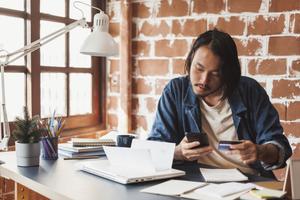 A man makes a minimum credit card payment.